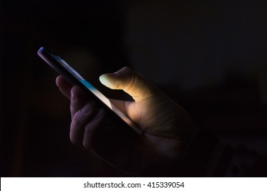 Man's Hand With A Smart Phone In A Dark