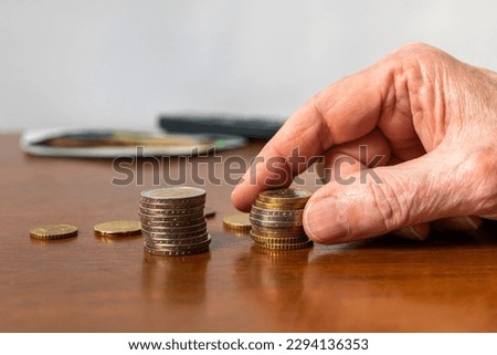 Man's hand stacking european coins on the table. Closeup. Foto stock © 