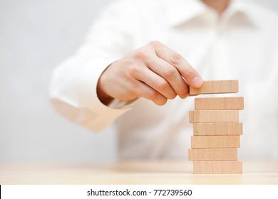 Man's Hand Stacking Wooden Blocks. Business Development Concept. 