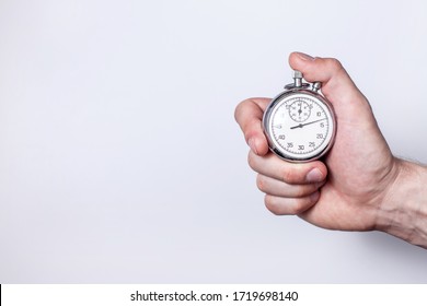 a man's hand with a stopwatch on a white background in the left part of the text space