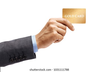 Man's hand in suit holding gold credit card isolated on white background. High resolution product. Close up.