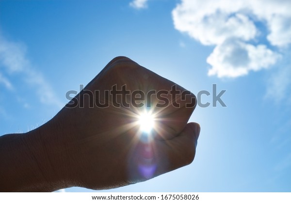 Man\'s hand and the\
sun