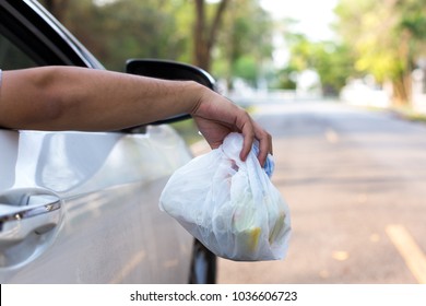 Man's Hand Throwing Trash Out Of Car Window, Close Up