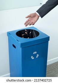 Mans hand throws the batteries into a special trash can for the separate collection of hazardous waste. Environment ecology concept. Illustrative editorial.  - Shutterstock ID 2137402725