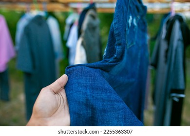 Man's hand touching denim fabric. Blue jeans. - Shutterstock ID 2255363307