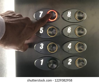 Man's hand touching elevator buttons. use of elevator