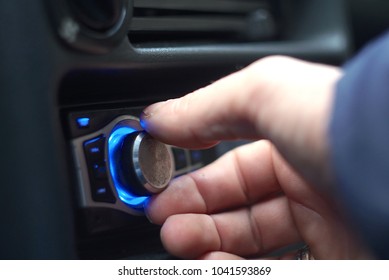 Man's Hand Tuning Radio In The Car. 