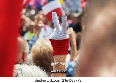 A man's hand and two fingers form the letter V. Freedom.