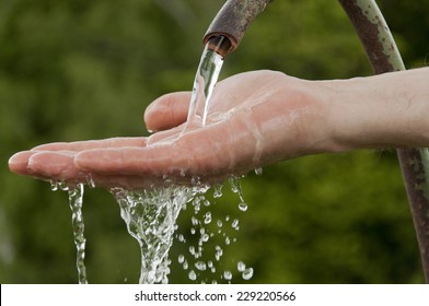 Man's Hand Under Running Cold Water