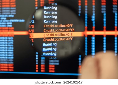 Man's hand uses a magnifying glass to closely examine a computer screen highlighting recurring CrashLoopBackOff error messages, symbolizing the focused process of diagnosing critical technical issues