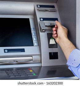 Man's hand using the ATM 