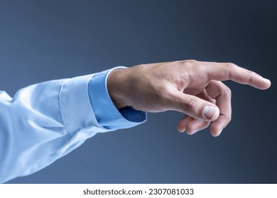 Man's hand wearing lab coat pointing index finger on grey background. Side view. - Shutterstock ID 2307081033