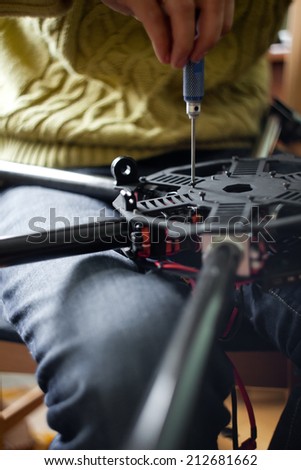 Man's hands assembling multicopter closeup