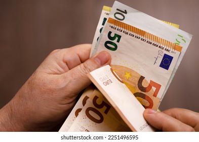 Man's hands counting euro banknotes. Close-up of male hands counting money.