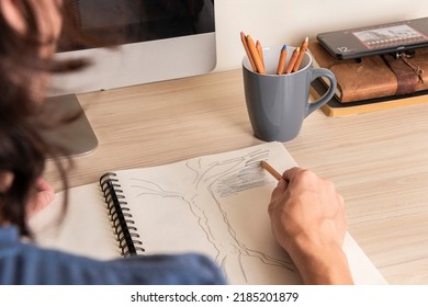 Man's hands drawing in