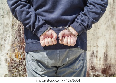 Man's Hands In Handcuffs