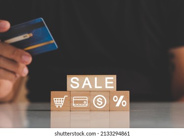 Man's Hands Holding Credit Card With Sales Icons. Icon Graph And Shopping Cart Symbol. Sale Volume Increase Make Business Grow Concept. 