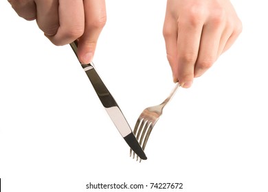 mans hands are holding fork and knife isolated on white background, are ready to cut and take next peace of food or any other object
