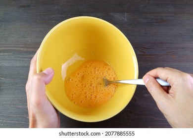 Mans Hands Holding Mixing Bowl While Beating Eggs For Cooking