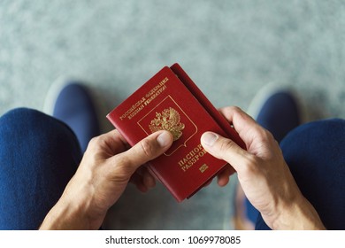 Man's Hands  Holding Passport, Top View