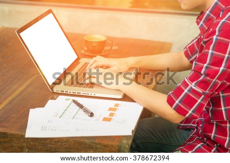 man's hands keyboarding on net-book while sitting at the wooden table in cafe,student working  laptop computer with copy space screen for your text ,male freelancer,vintage color.
