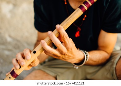 Man's Hands Playing Indian Flute Bansuri, Close Up