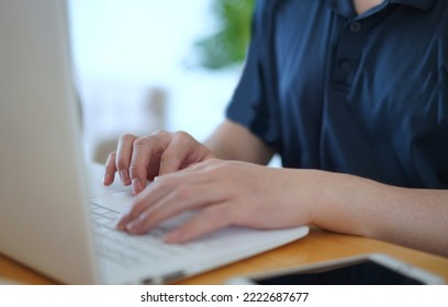 man's hands type keyboard notebook computer on table at home - Shutterstock ID 2222687677