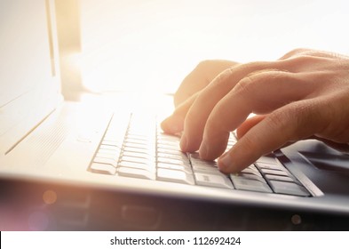 Man's hands typing on laptop keyboard - Shutterstock ID 112692424