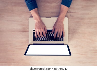 Man's Hands Using Laptop With Blank Screen On Desk In Home Interior. - Top View