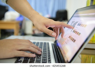 a man's hands using a laptop at home, rear view of business man hands busy using laptop at office desk