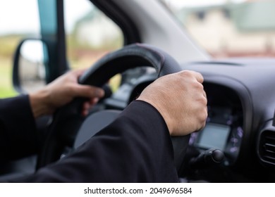 Man's hands at the wheel of a car. Safe driving. Drunk driving. Falling asleep behind the wheel.