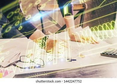 Man's hands working with notes background. Modern computer record diagram with virtual mnitor.