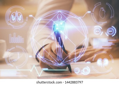 Man's hands working with notes background. Modern computer record diagram with virtual mnitor. - Shutterstock ID 1442883797