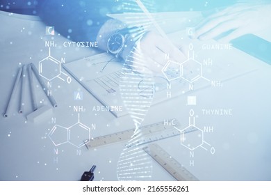 Man's hands working with notes background. Genetic engineering and gene manipulation concept. Double exposure.