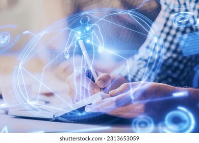 Man's hands working with notes background. Modern computer record diagram with virtual mnitor. Education concept. Double exposure.