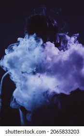 a man's head, in front of which there is a lot of white smoke. the face is not visible. color accents with light