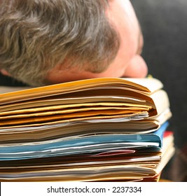 Man's head on pile of files