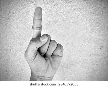 man's left hand, pointing the index finger upwards - Shutterstock ID 2340592055