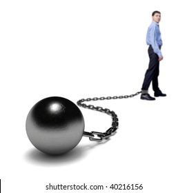 Man's legs dragging a ball and chain, selective focus.