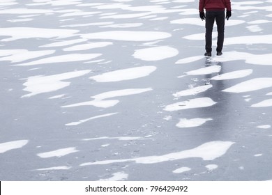 Man's Legs With Shadow On The Lake Ice. Cold Atmosphere. Dangerous Walking On The Thin Ice. Winter Concept.