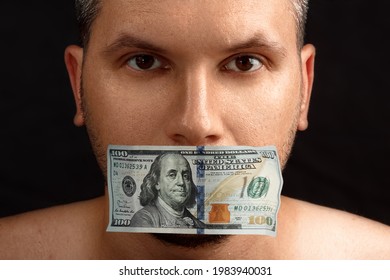The man's mouth is sealed with dollars, money. The concept of buying silence, corruption, lobbyists for money