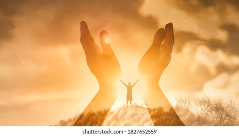 Mans worshiping hands raised up with open palms to the sunset sky. Religion and spirituality belief concept. 