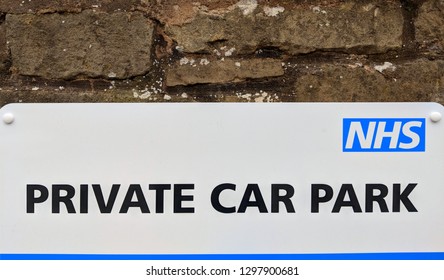 MANSFIELD, ENGLAND - JANUARY 25, 2019:  NHS Private Staff Car Park Sign At A Hospital / Doctors Office, Attached To A Stone Wall