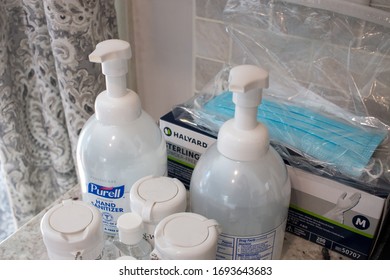 Mansfield, Massachusetts / United States Of America - April 4 2020: Face Masks And Hand Sanitizer On A Home Kitchen Counter To Prevent The Spread Of Coronavirus