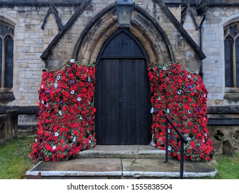 MANSFIELD, UK - NOVEMBER 10, ‎2019: St Edmund's Church Entrance Surrounded By Poppies, A Symbol Of Armistice Day, (also: Poppy Day, Remembrance Sunday) In Memory Of Those Who Have Died In Line Of Duty