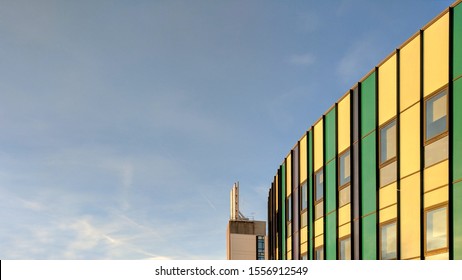 MANSFIELD, UK - NOVEMBER 11, 2019:  Exterior Of The Steel & Glass, Green & Yellow Front Of Kings Mill Hospital In Dark Twilight, Refurbished & Remodeled In 1960s Style Under Tony Blair's Government