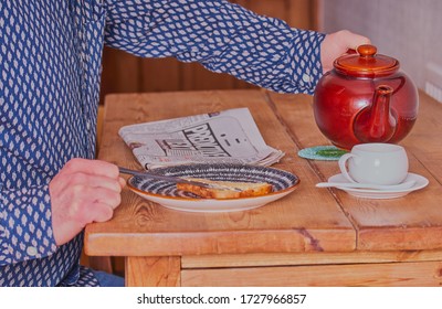 Mansfield,Nottinghamshire,Great Britain,5/2/2020,12:19 Pm, Person Sat At Breakfast Table Pouring A Cup Of Tea,about To Read Newspaper. 