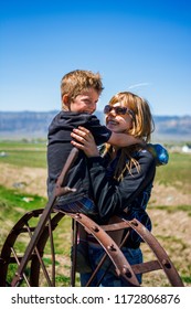 Manti, UT / United States - April 4, 2015: Young Woman Laughing And Hugging Little Boy Outside 