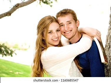 Manti, UT/ United States - May 15, 2014: Young Couple Hugging And Laughing In The Park 