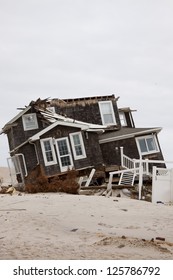 MANTOLOKING, NJ - JAN 13: A Tilted House Off Its Foundation On The Beach On January 13, 2013 In Mantoloking, New Jersey. Clean Up Continues 75 Days After Hurricane Sandy Struck In October 2012.